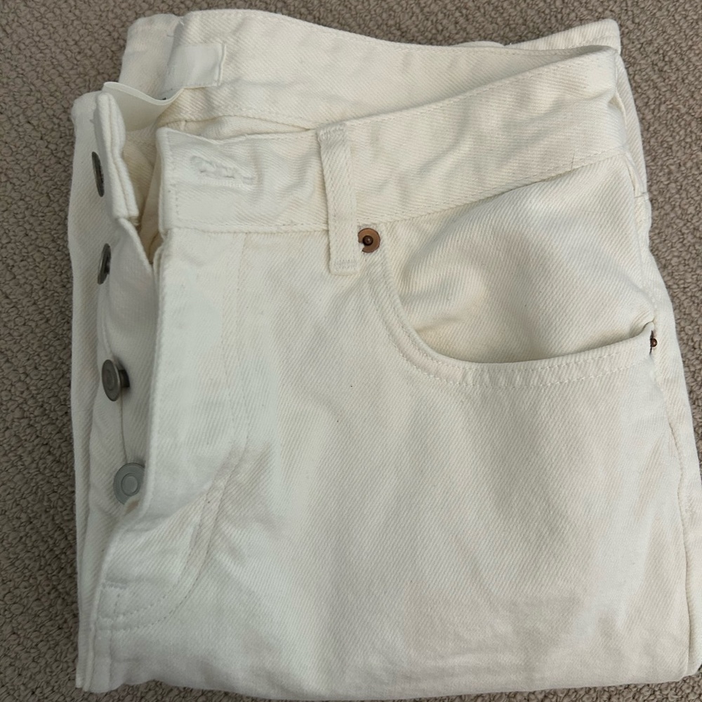 White jeans with buttons.